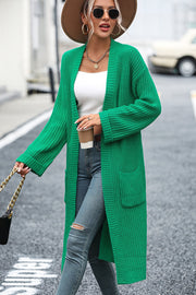 Green longline knit cardigan with pockets and ribbed texture.
