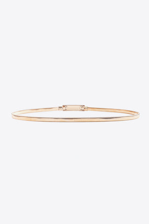 Slimline gold-tone metal waist belt with adjustable buckle closure