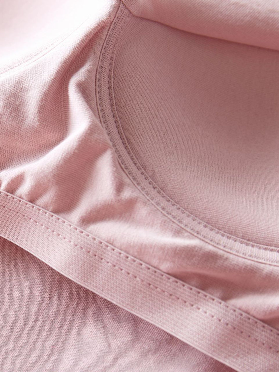 Pale Blush built-in support tank top detail showing seams and soft fabric.