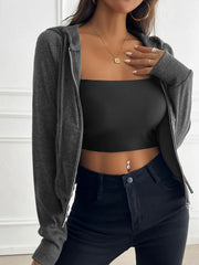Dark gray ribbed crop hoodie with silver zip detail, open and worn over a black tube top.