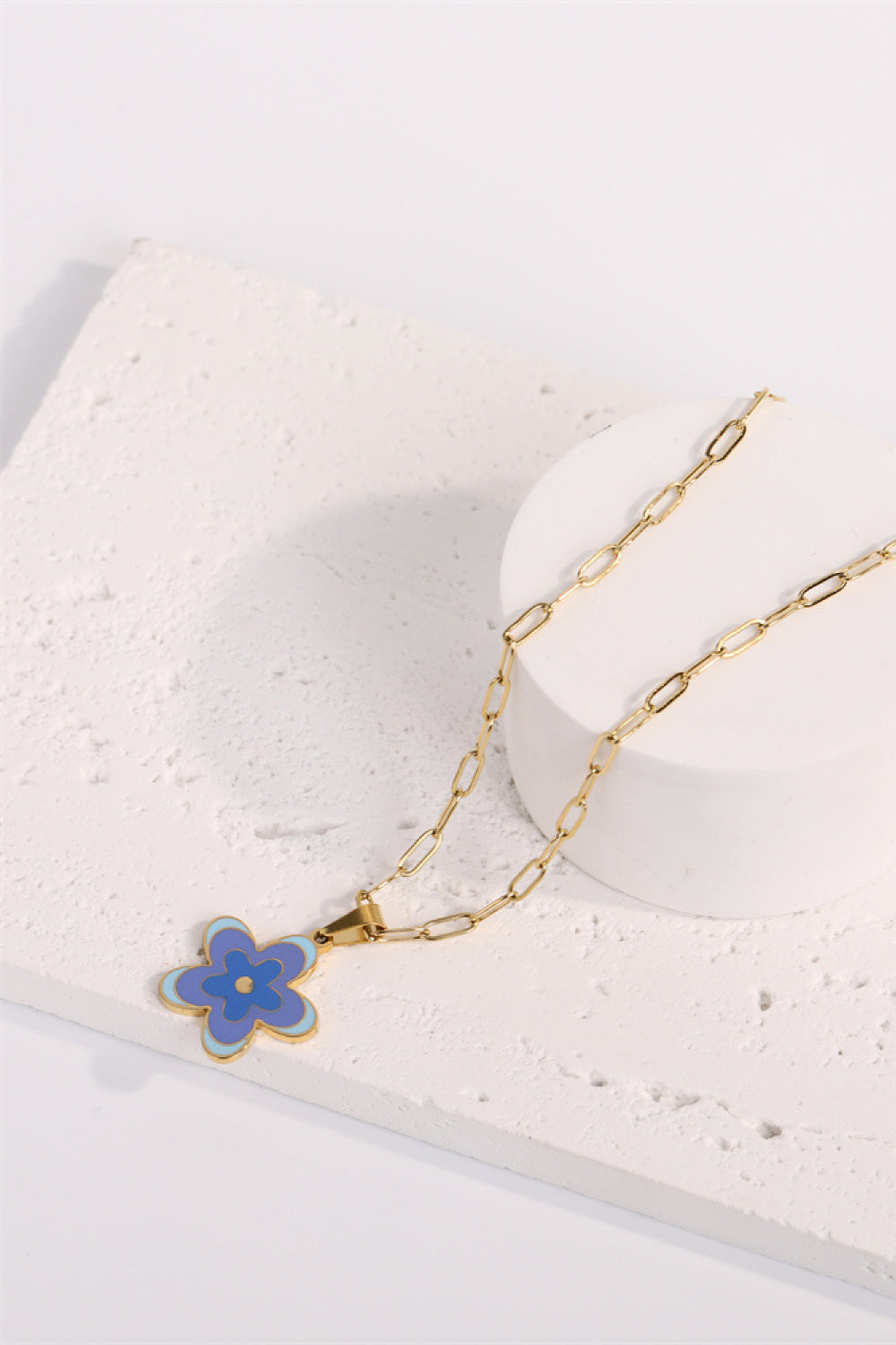Enamel floral pendant chain necklace with gold-plated paperclip chain, featuring a blue and light blue flower charm.
