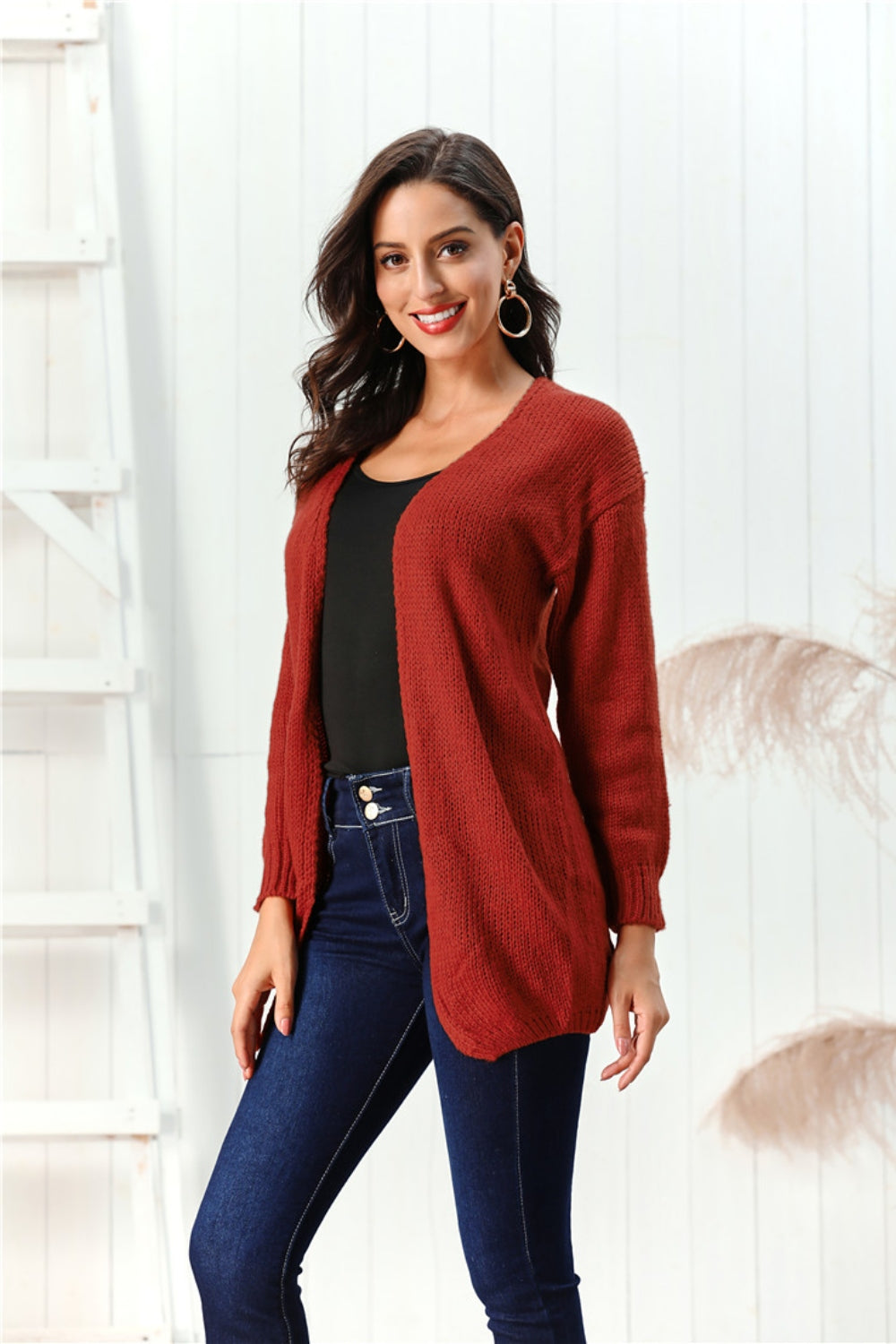 Draped knit open-front cardigan in deep red, 100% acrylic, with long sleeves and a relaxed fit.