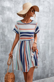 Striped yoke-seam trapeze dress in multi-color stripes with short sleeves and a round neckline.