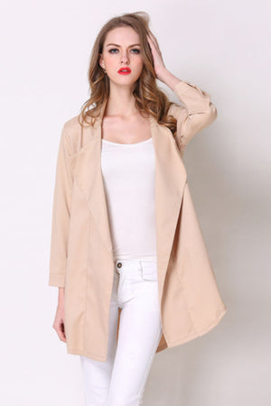 Tan drape-front trench coat with shoulder detailing and buttoned cuffs.