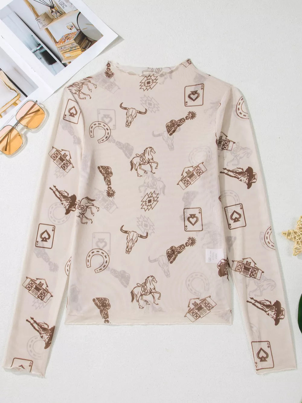 Sheer mesh mock neck shirt with western print, long sleeves, and lettuce hem.
