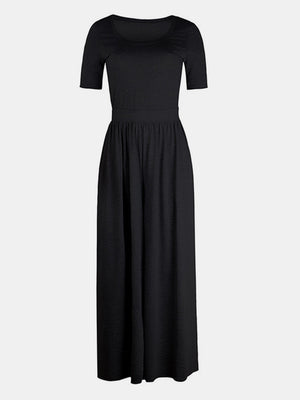 Black textured wide-leg jumpsuit with short sleeves and subtle elastic waist