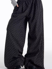 Men's relaxed fit black wide leg sweatpants with a subtle floral pattern.