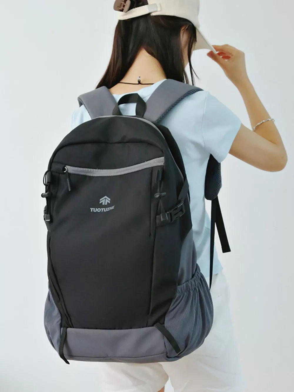 Black nylon backpack with grey accents and side mesh pockets.