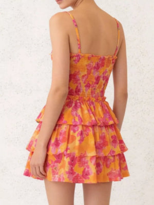 Floral cutout mini dress with tiered skirt in orange and pink floral print.