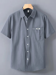Men's dark gray short-sleeve button-up shirt with a chest pocket and white buttons.