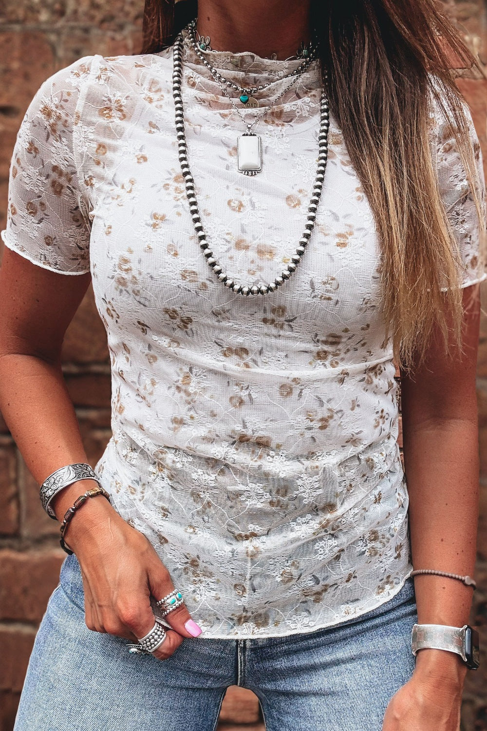 Lace mock neck t-shirt with short sleeves and a floral print.