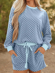 Light blue checkerboard loungewear set with crewneck pullover and drawstring shorts.