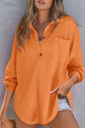 Waffle knit henley shirt in tangerine with button front, collar, and chest pocket.