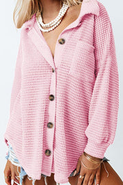 Blush pink waffle knit button-down shirt jacket with a collared neckline and chest pocket.