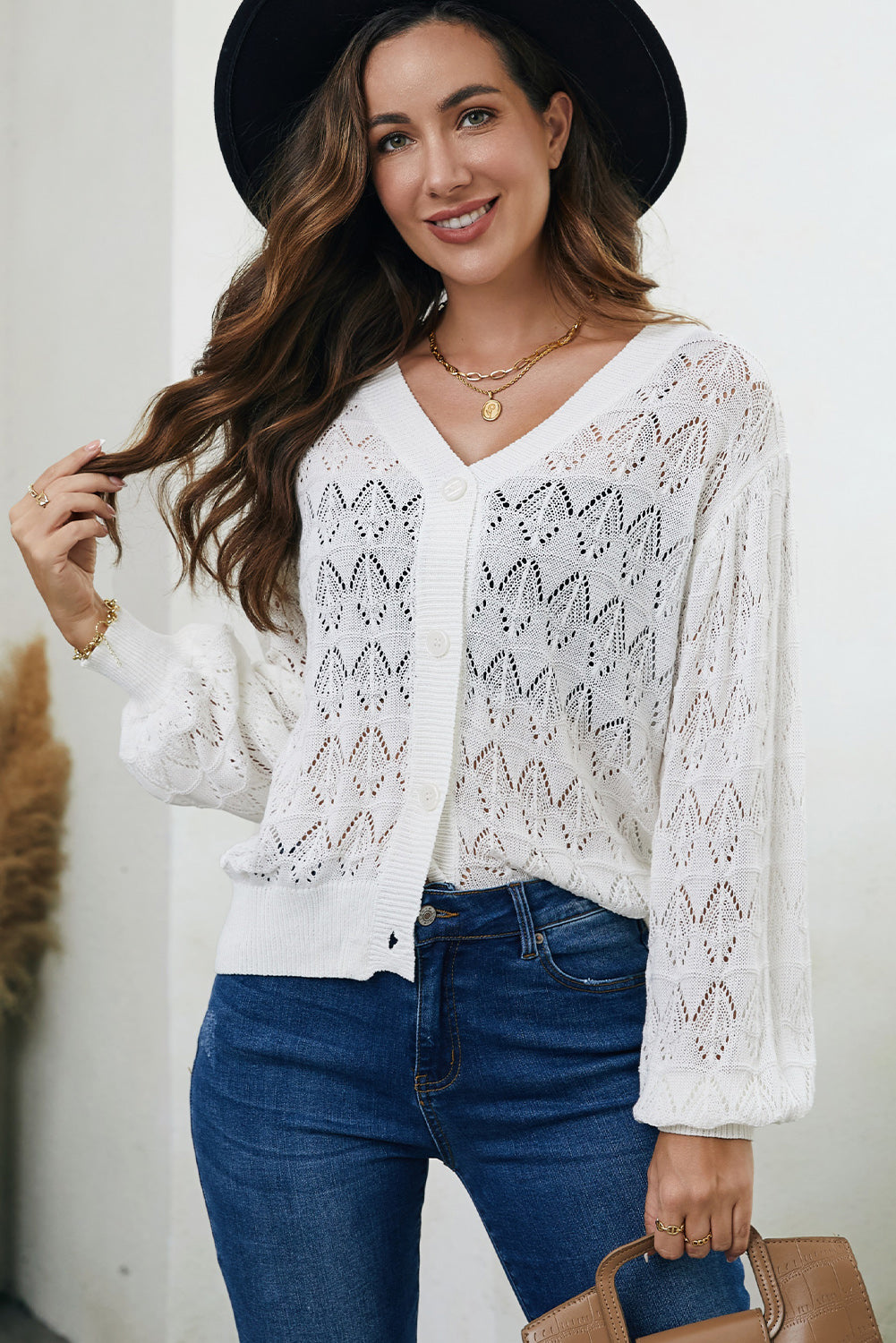 White openwork knit cardigan with balloon sleeves and button front.