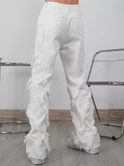 White wide-leg jeans for men with distressed fringe detailing on the legs.