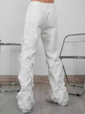 White wide-leg jeans for men with distressed fringe detailing on the legs.