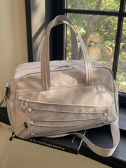 Grey nylon travel organizer bag with adjustable strap and bungee cord detail.