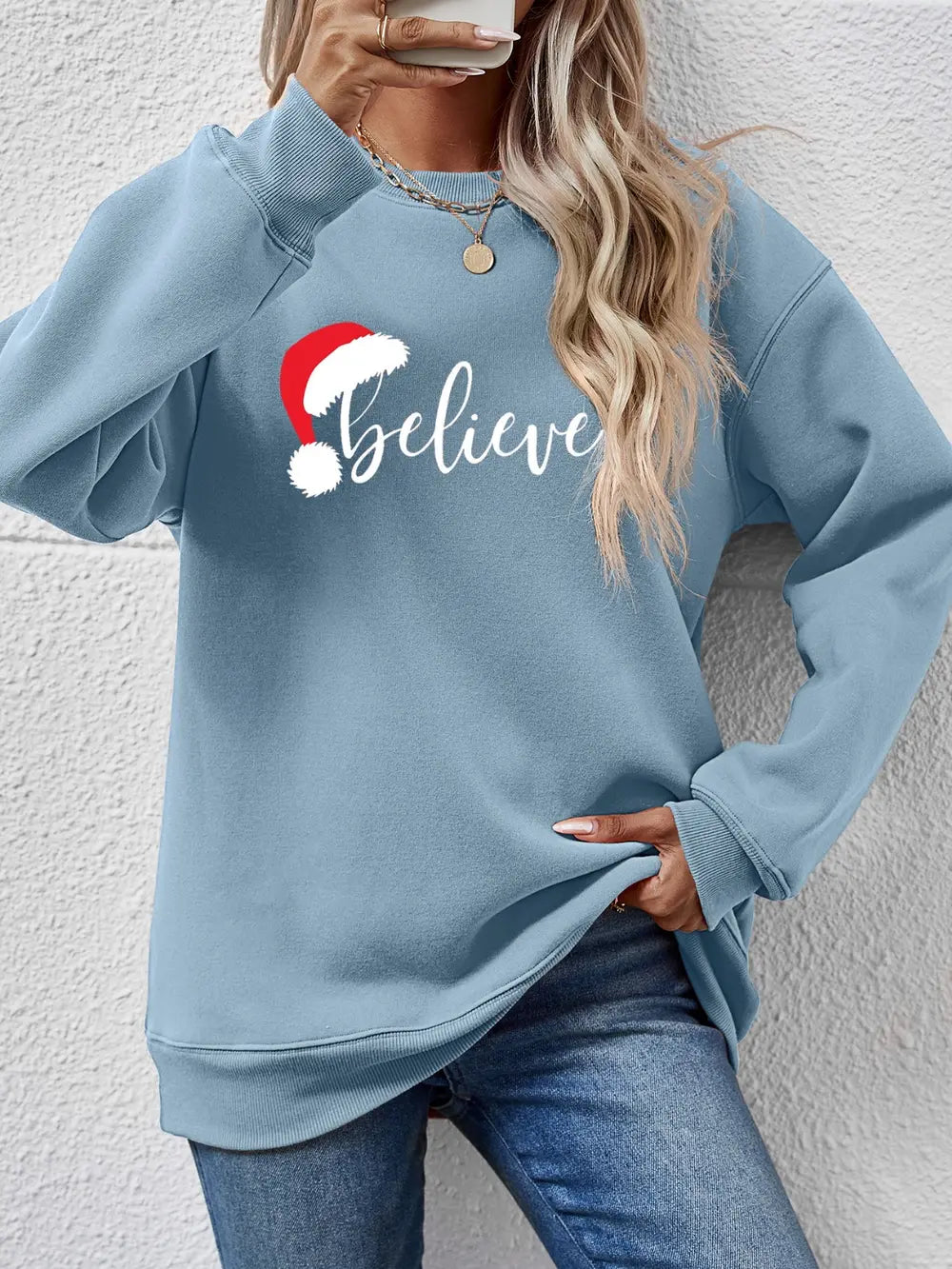 Light Blue raglan sweatshirt with "Believe" and Santa hat graphic.