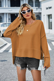 Ochre acrylic knit sweater with flared sleeves and split hem detail.