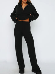 Black ribbed knit quarter-zip lounge set with wide-leg pants.