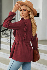 Burgundy textured peplum blouse with ruffle detail and long sleeves