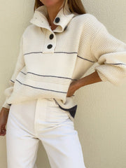 Cream waffle knit button-up collar sweater with navy stripes and black buttons.