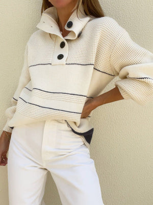 Cream waffle knit button-up collar sweater with navy stripes and black buttons.