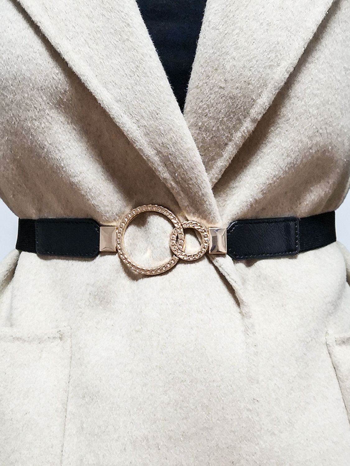 Black elastic belt with interlocked gold rings and crystal detail buckle
