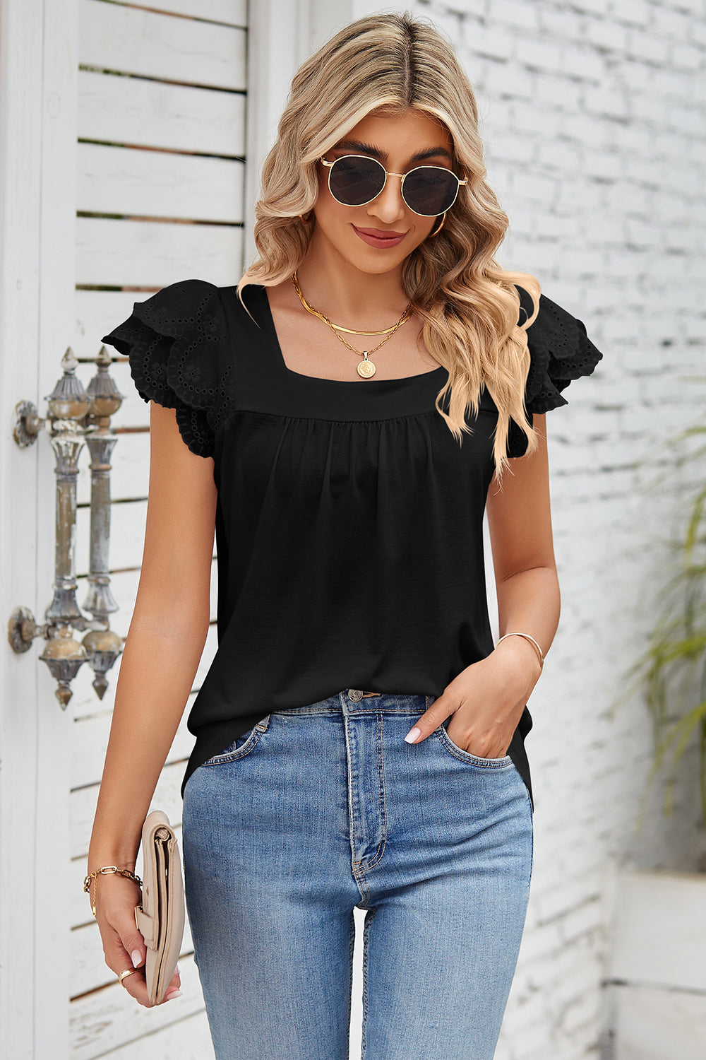 Black eyelet flutter sleeve square neck blouse with gathered neckline.