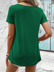 Green t-shirt with short sleeves and a floral lace yoke detail.