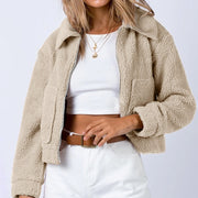 Sand textured sherpa cropped jacket with collar and zip front, styled with a white crop top.