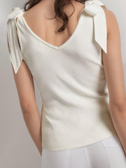White ribbed knit tank top with V-neck and bow shoulder straps