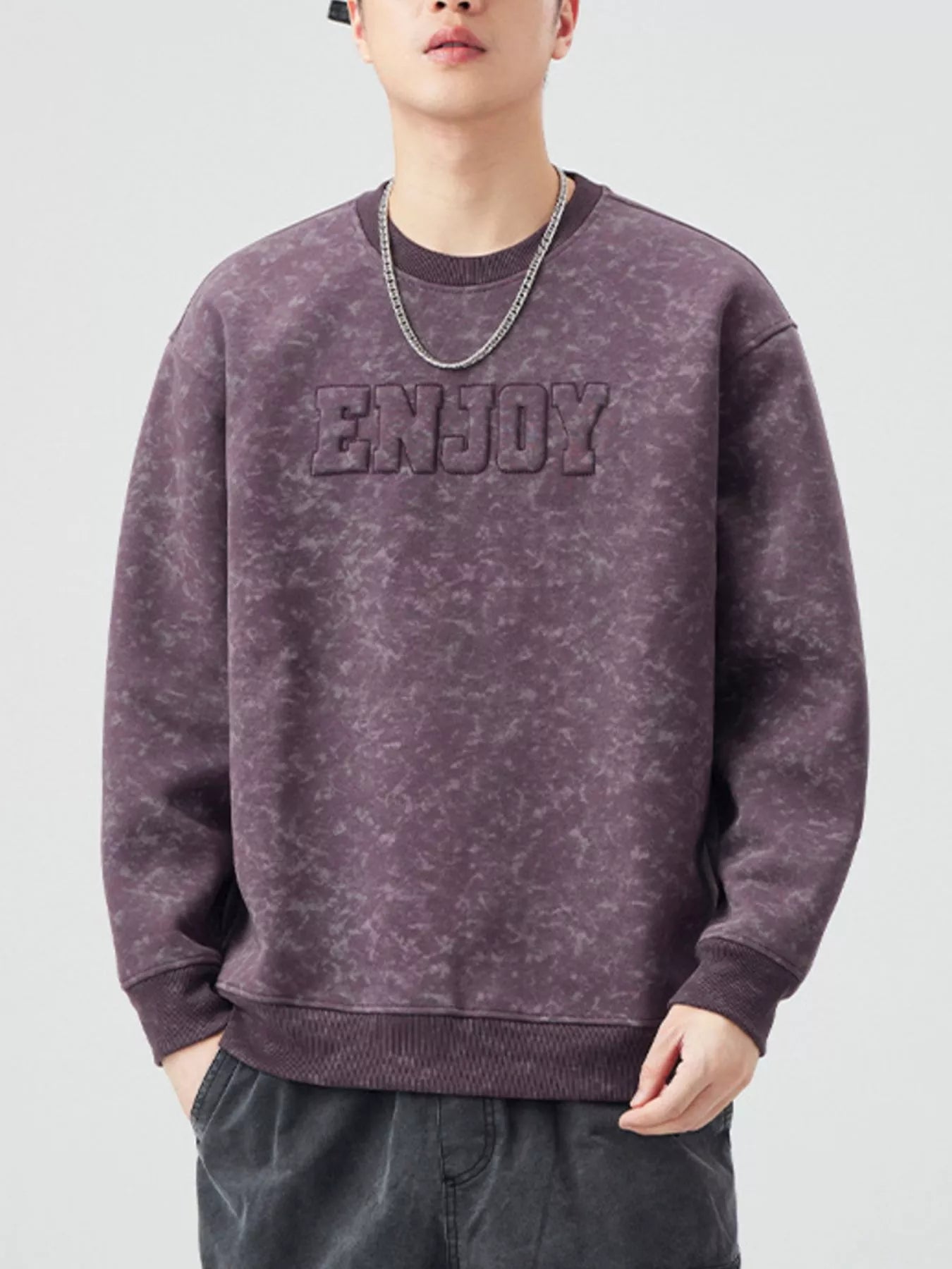 Men's purple tie-dye crewneck sweatshirt with embossed "ENJOY" graphic.