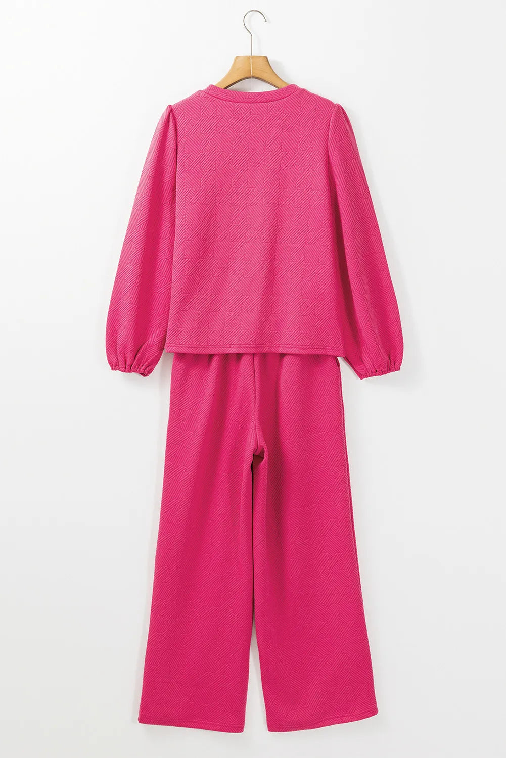 Textured puff sleeve lounge set in hot pink with a geometric pattern.