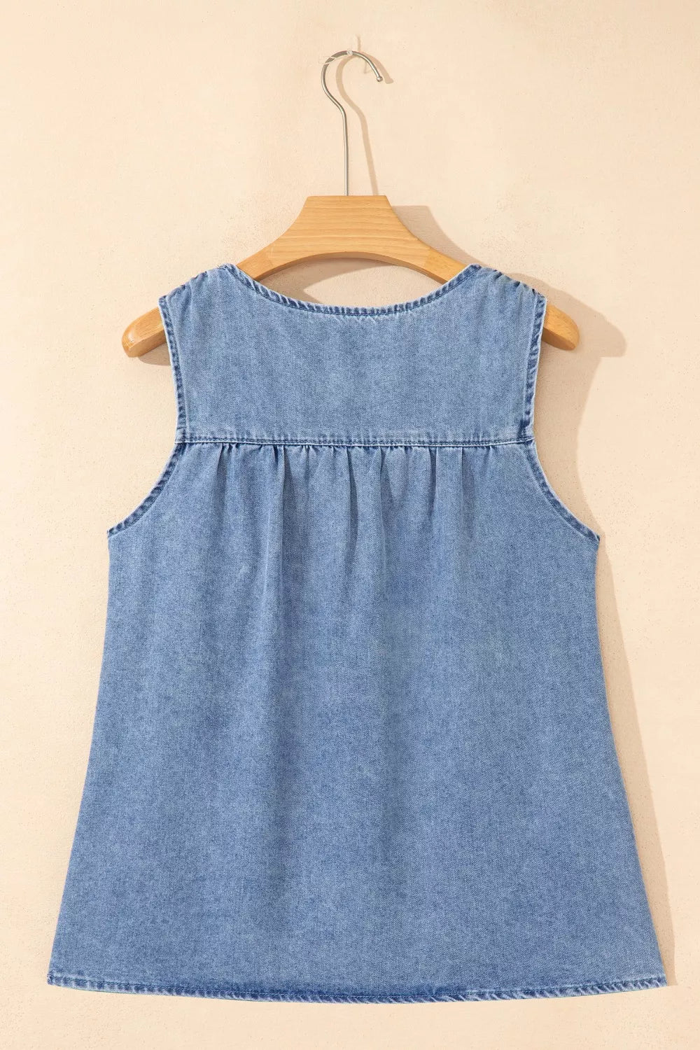V-neck pleated denim sleeveless top in light blue with a casual cut.