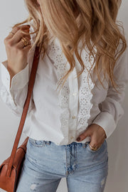 White cotton shirt with eyelet ruffle front detail and button closure.
