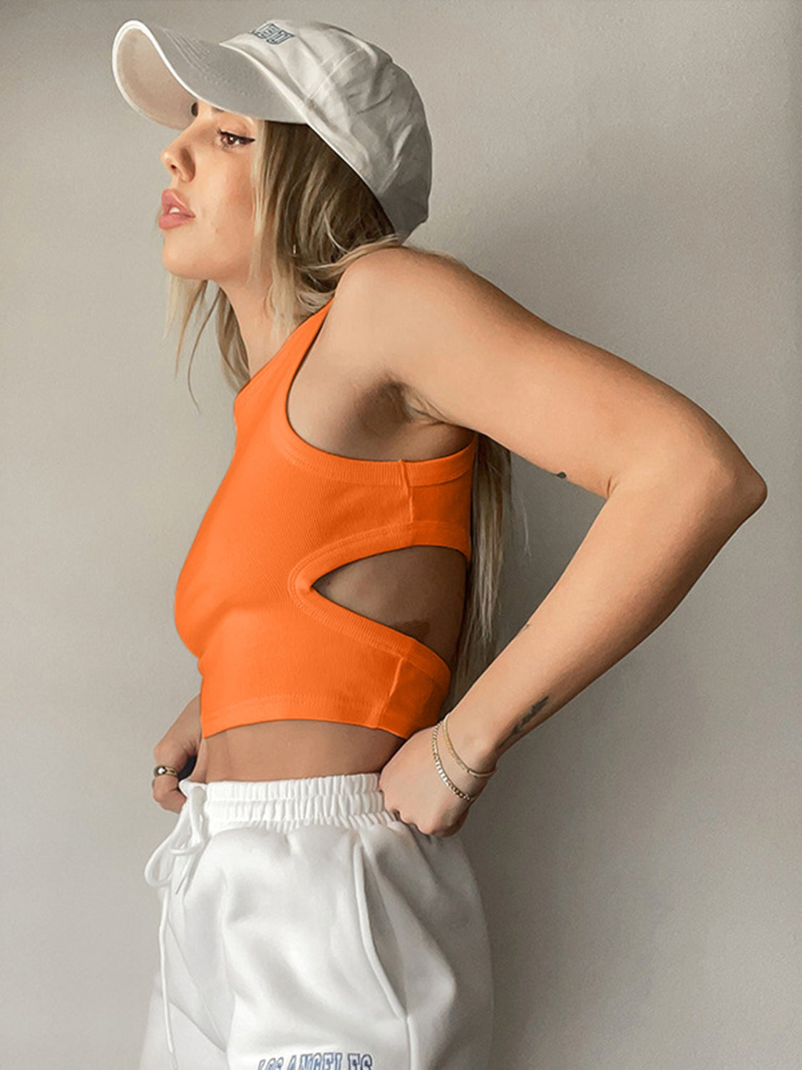Orange ribbed crop top with cutout sides and a racerback.
