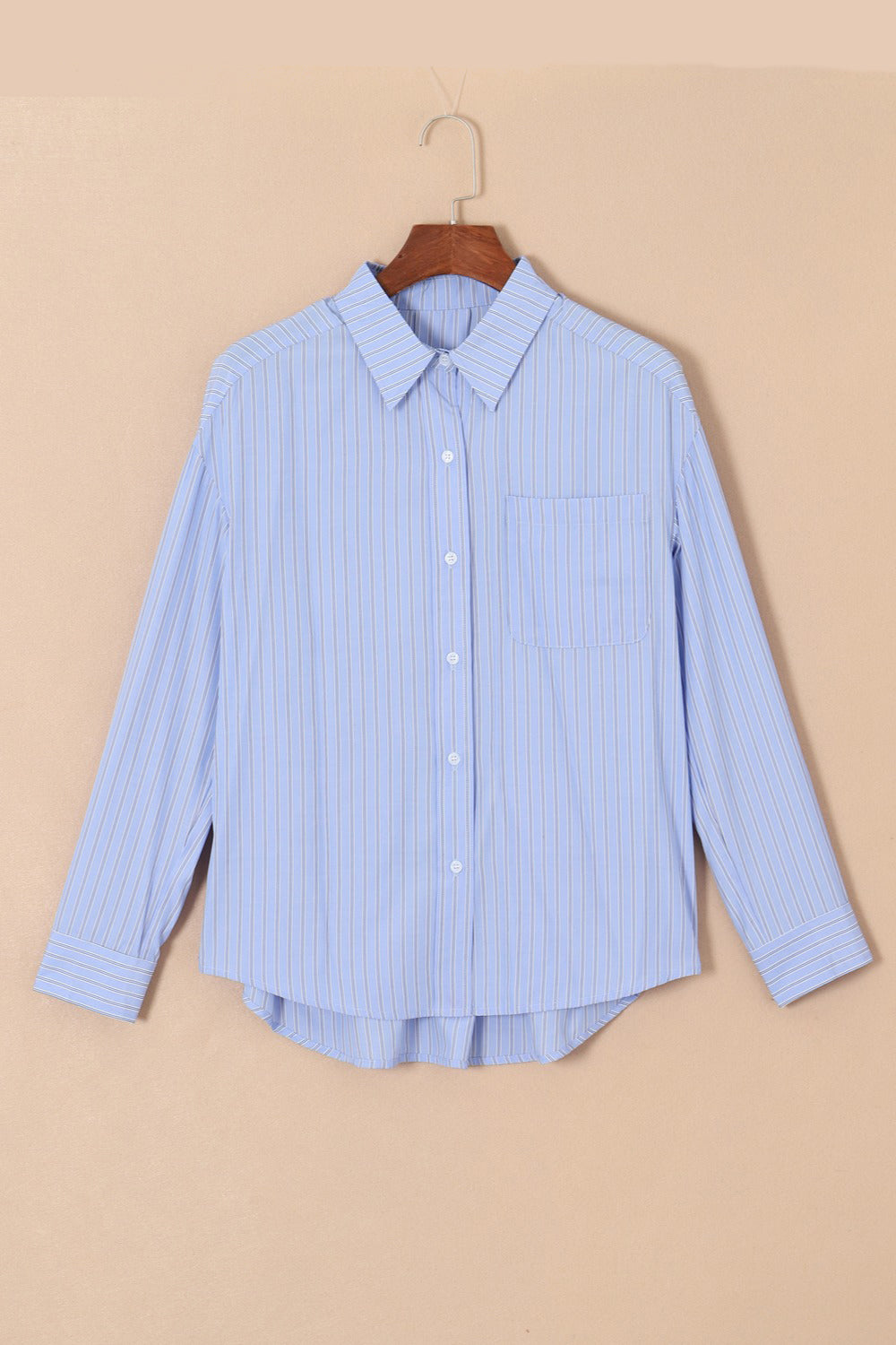 Light blue striped oversized Oxford shirt with button front and chest pocket.