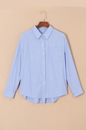 Light blue striped oversized Oxford shirt with button front and chest pocket.