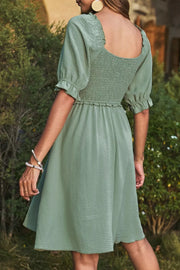 Sage smocked mini dress with square neckline and ruffled short sleeves
