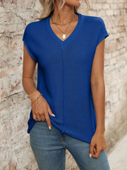 Royal blue seamed knit sleeveless v-neck top with a vertical seam detail.