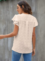 Textured voile blouse in white with flutter sleeves and a dotted pattern.
