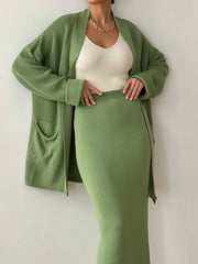 Ribbed knit co-ord set in Gum Leaf green, featuring a long sleeve cardigan with pockets and a midi skirt.