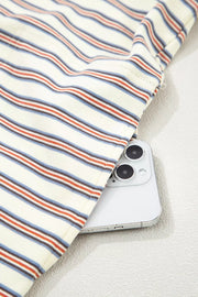 Casual striped mini dress in cotton with side pockets, showing a phone tucked in.