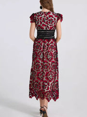 Burgundy floral lace midi dress with black waistband and cap sleeves.