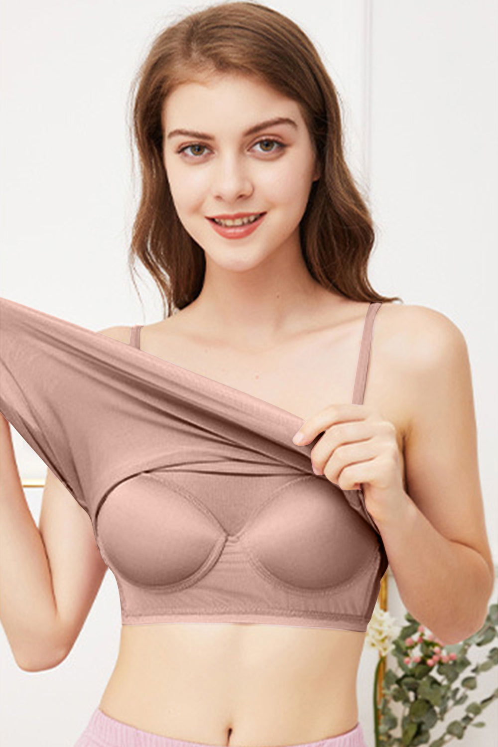 Seamless scoop neck camisole in blush pink with built-in bra cups.