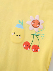 Yellow baby tee with playful fruit and flower applique details.