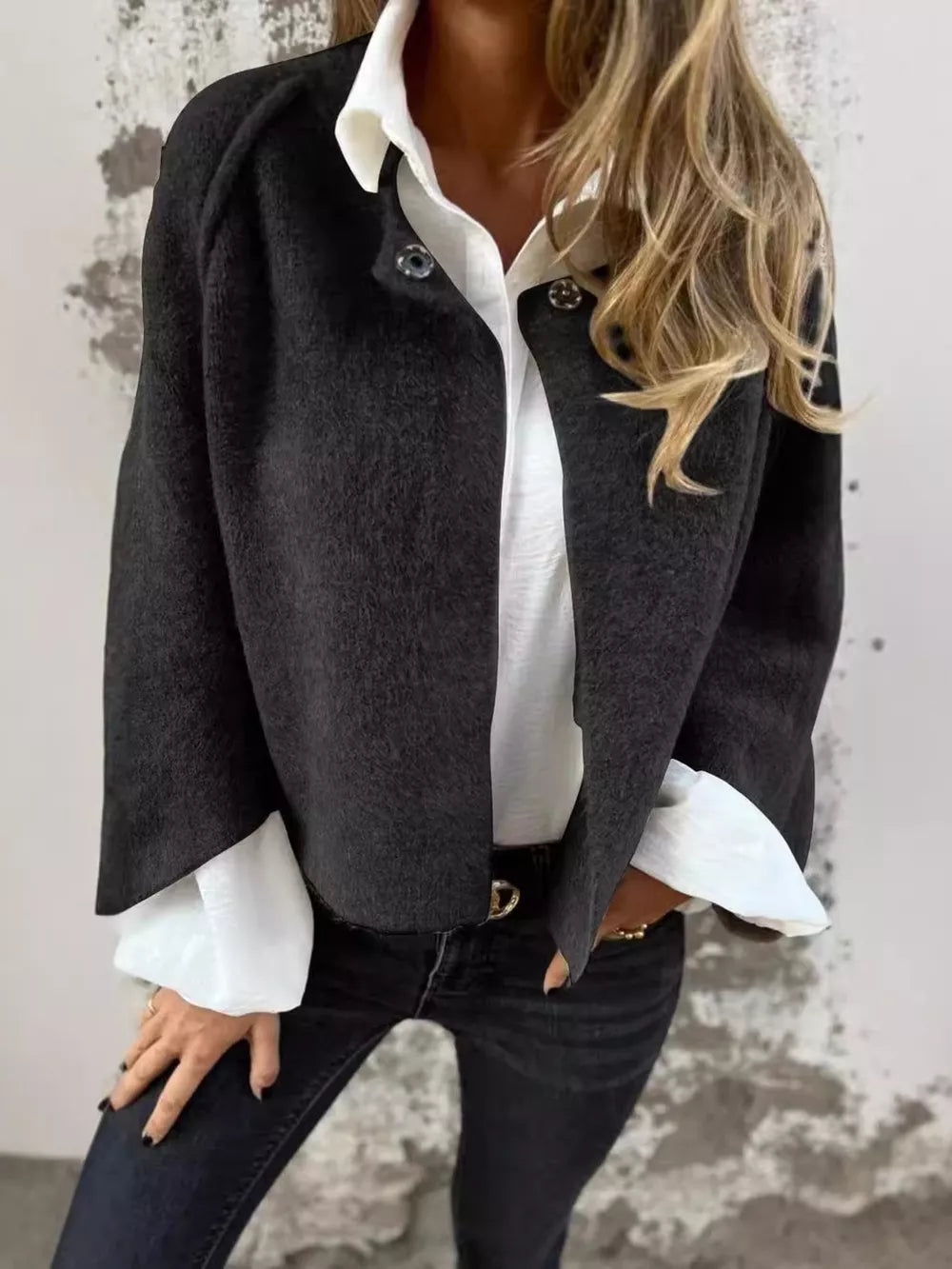 Cozy fuzzy knit cardigan in black with button detail and wide sleeves.
