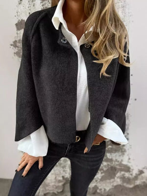 Cozy fuzzy knit cardigan in black with button detail and wide sleeves.